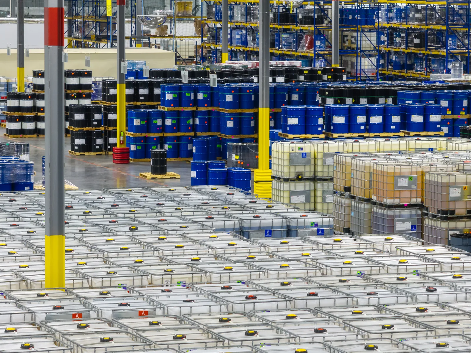 Ultimate Linings warehouse with drums and totes of polyurea and polyaspartic coating materials staged for distribution