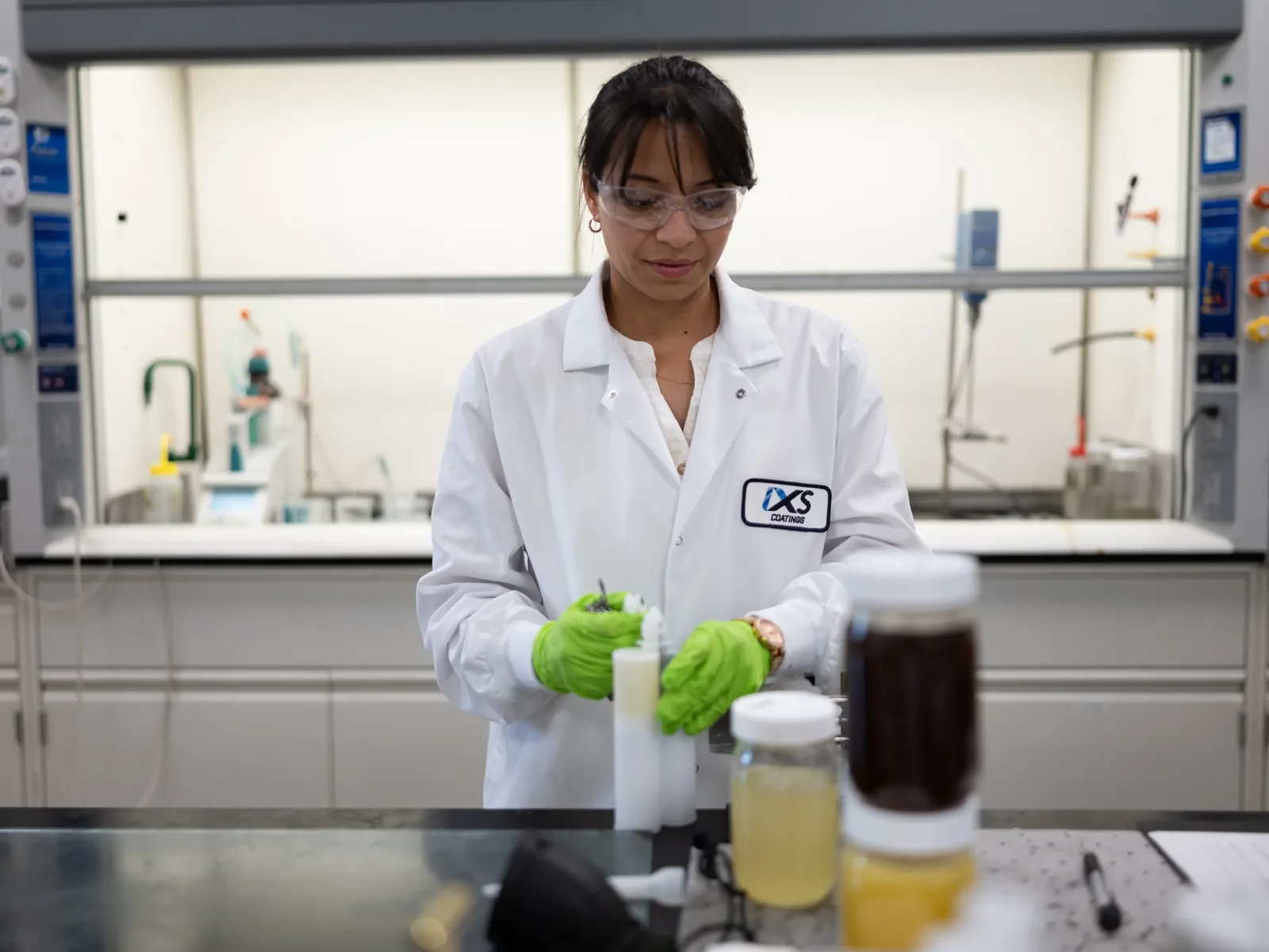 IXS Coatings technician preparing coating samples in the ISO/IEC 17025-accredited laboratory